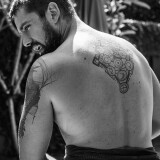 Photo-by-Sergio-Baia-on-April-01-2023.-May-be-a-black-and-white-image-of-1-person-beard-biceps-tattoo-and-sarong.