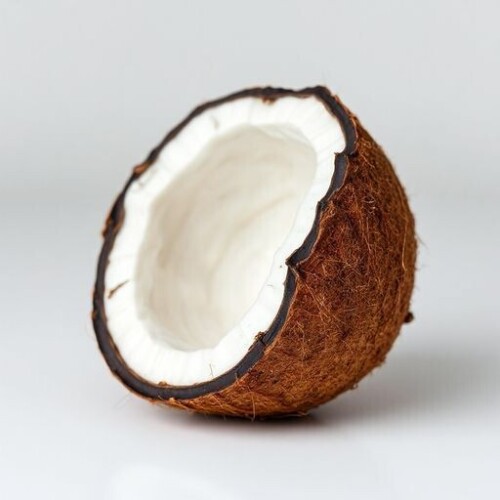 High-resolution-image-of-a-broken-coconut-with-a-cracked-shell-and-exposed-white-flesh-on-a-clean-and-minimalist-background-with-a-shallow-depth-of-field-and-a-focus-on-the-coconuts-texture-512_512px.jpg